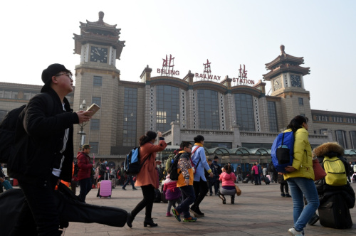 2月12日，在北京火車站，旅客走過站前廣場。當日是正月初五，隨著春節(jié)假期接近尾聲，探親、旅游的人們陸續(xù)返程，全國各地迎來返程客流高峰。新華社記者 鞠煥宗 攝